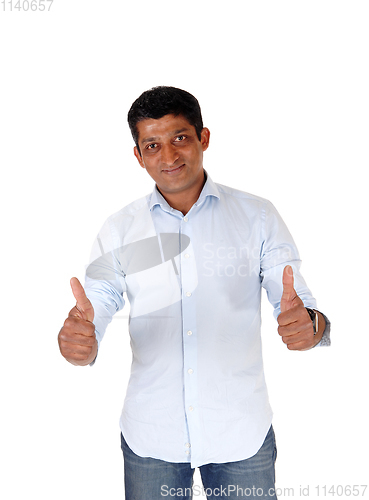 Image of Handsome man standing with two thumps up