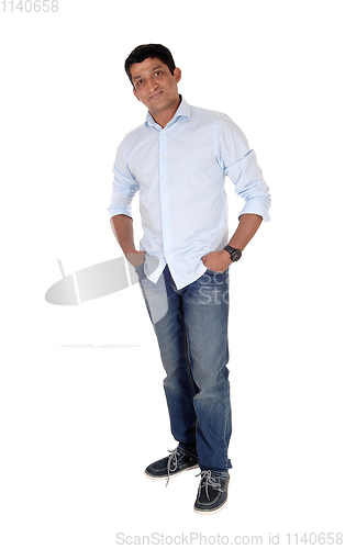 Image of Relaxed Indian man standing in jeans and sneakers