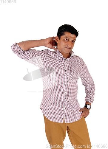 Image of Man standing in brown pants and red checkered shirt