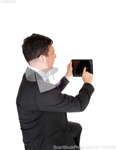 Image of Business man looking at his tablet PS