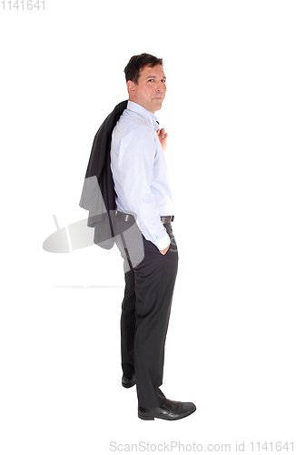Image of A business man standing with his jacked over shoulder