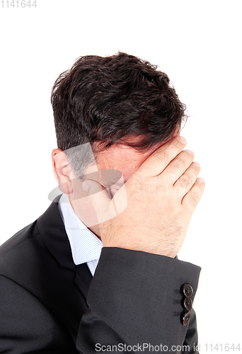 Image of Business man covering is face he is depressed