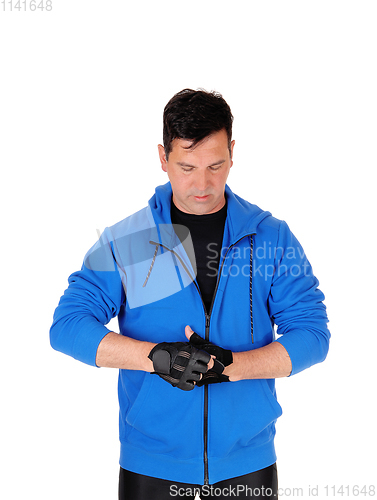 Image of Handsome man in blue jacket with cloves