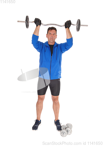 Image of Tall man lifting the weight over his head