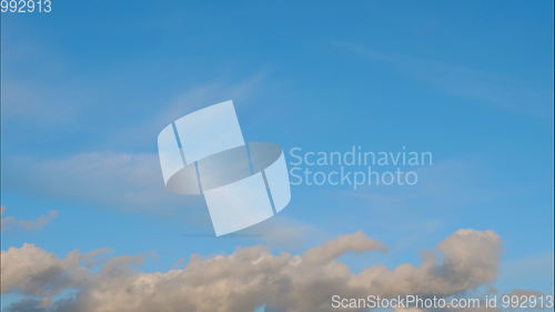 Image of Time lapse Fluffy clouds float across the blue sky. UltraHD stock footage