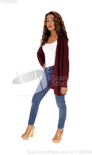 Image of Tall young woman standing in jeans 