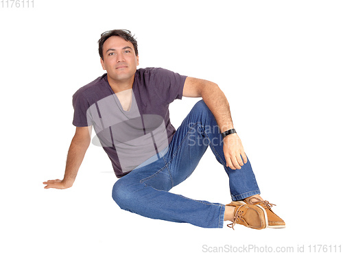 Image of A handsome tall man siting on the floor