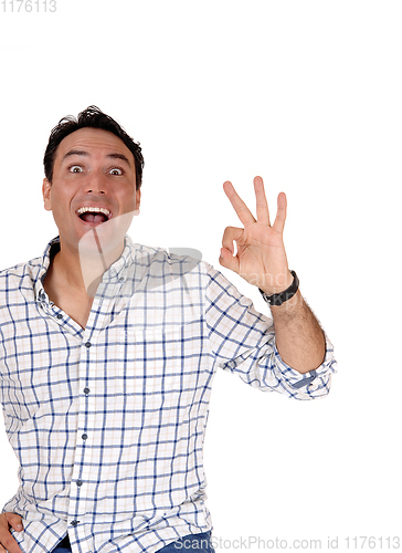 Image of Happy young man signs OK with his finger