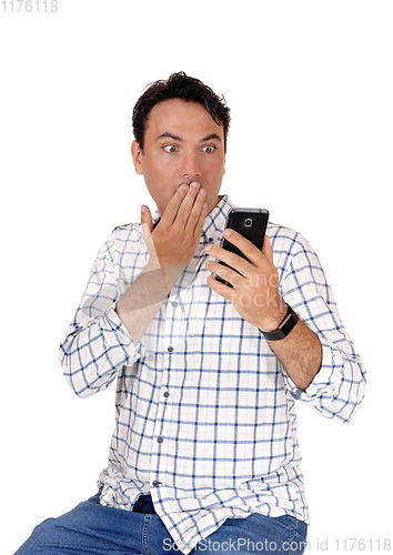 Image of Man is surprised what he see's on his phone