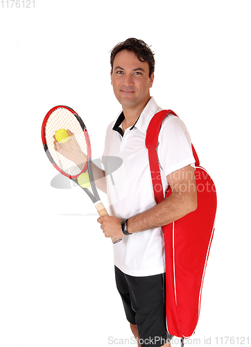 Image of Man standing with his tennis tools, smiling