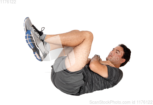 Image of Man doing sit-ups on the floor