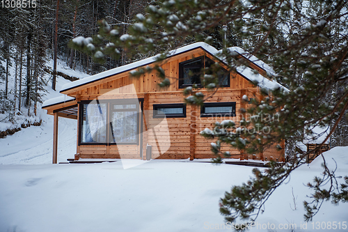 Image of Winter holiday house in forest.