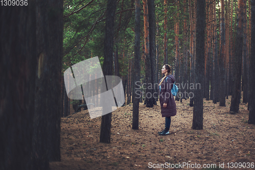 Image of Woman in the autumn dark forest