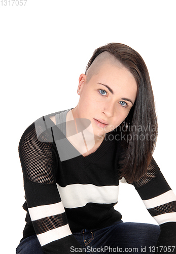 Image of Lovely woman sitting and looking at camera