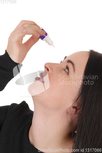 Image of Woman putting eye drops in her dry eyes