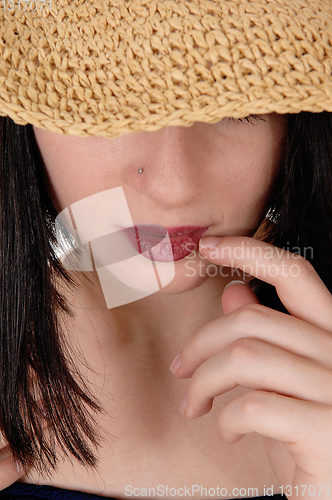 Image of Mysterious woman with big straw hat in close up