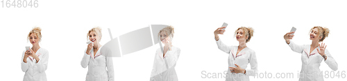 Image of Portrait of female doctor in white uniform using phone isolated over white background