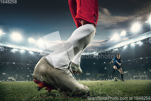 Image of Close-up leg football or soccer player at stadium in flashlights - motion, action, activity concept. Flyer for ad, design.