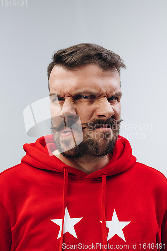 Image of Young man with dual emotions combination on face isolated on white background, emotional and expressive