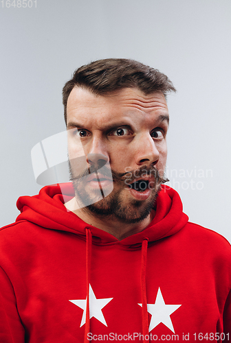 Image of Young man with dual emotions combination on face isolated on white background, emotional and expressive