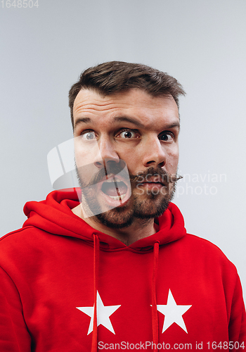 Image of Young man with dual emotions combination on face isolated on white background, emotional and expressive