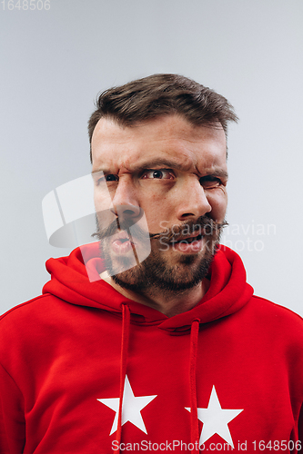 Image of Young man with dual emotions combination on face isolated on white background, emotional and expressive