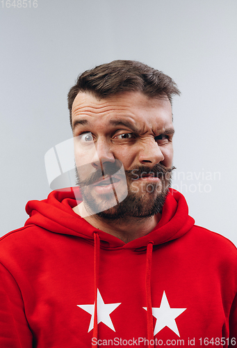 Image of Young man with dual emotions combination on face isolated on white background, emotional and expressive