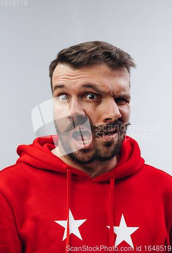 Image of Young man with dual emotions combination on face isolated on white background, emotional and expressive