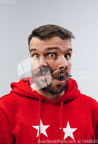 Image of Young man with dual emotions combination on face isolated on white background, emotional and expressive