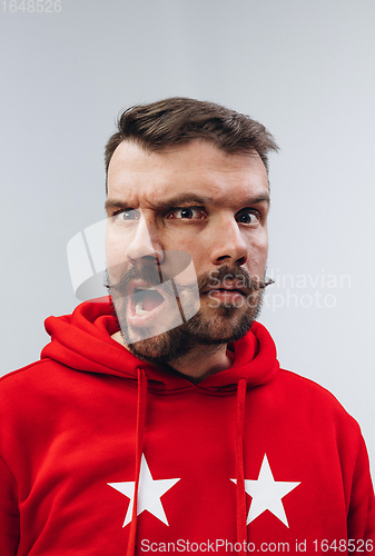 Image of Young man with dual emotions combination on face isolated on white background, emotional and expressive