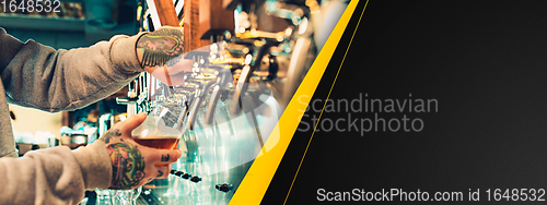 Image of Hand of bartender pouring a large beer in tap. Horizontal banner, flyer for ad.