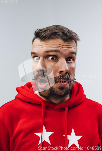 Image of Young man with dual emotions combination on face isolated on white background, emotional and expressive