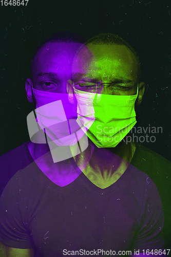 Image of Close up portrait of african man wearing face mask background. Modern and trendy duotone effect, double exposure