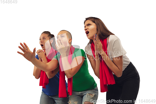 Image of Female soccer fans cheering for favourite sport team with bright emotions isolated on white studio background