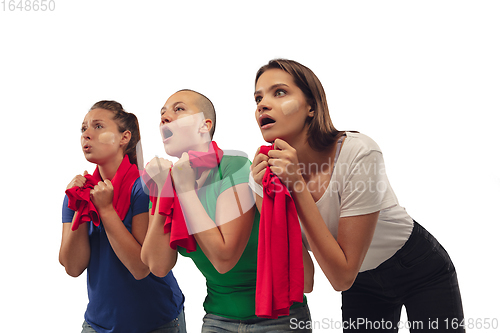 Image of Female soccer fans cheering for favourite sport team with bright emotions isolated on white studio background