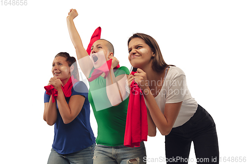 Image of Female soccer fans cheering for favourite sport team with bright emotions isolated on white studio background