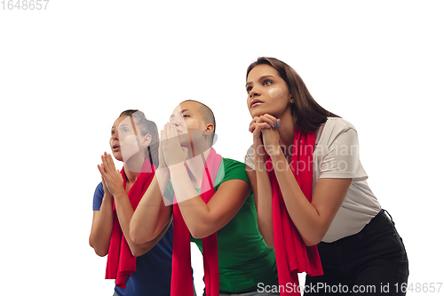 Image of Female soccer fans cheering for favourite sport team with bright emotions isolated on white studio background