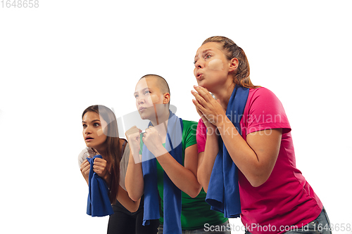 Image of Female soccer fans cheering for favourite sport team with bright emotions isolated on white studio background