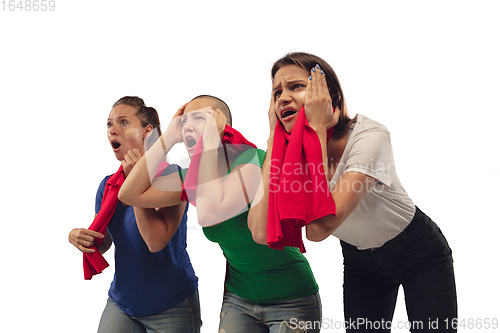 Image of Female soccer fans cheering for favourite sport team with bright emotions isolated on white studio background