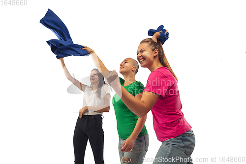 Image of Female soccer fans cheering for favourite sport team with bright emotions isolated on white studio background