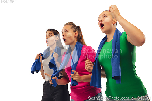 Image of Female soccer fans cheering for favourite sport team with bright emotions isolated on white studio background