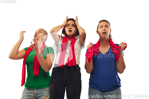 Image of Female soccer fans cheering for favourite sport team with bright emotions isolated on white studio background