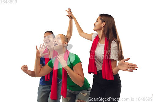 Image of Female soccer fans cheering for favourite sport team with bright emotions isolated on white studio background