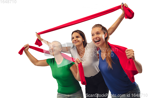 Image of Female soccer fans cheering for favourite sport team with bright emotions isolated on white studio background