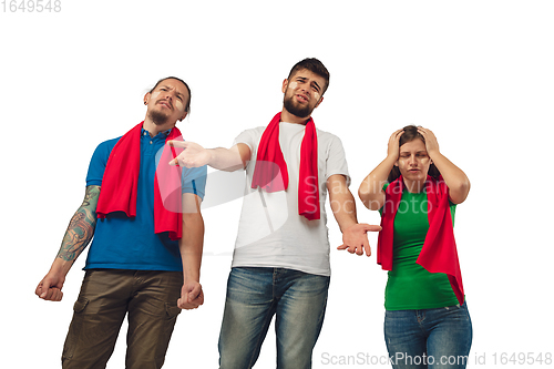 Image of Two men and woman as soccer fans cheering for favourite sport team with bright emotions isolated on white studio background