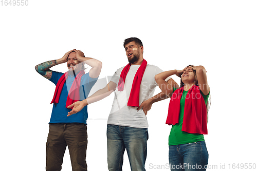 Image of Two men and woman as soccer fans cheering for favourite sport team with bright emotions isolated on white studio background