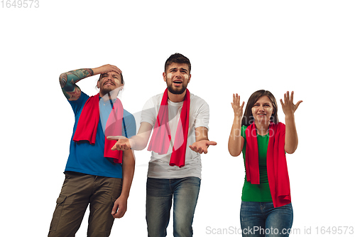 Image of Two men and woman as soccer fans cheering for favourite sport team with bright emotions isolated on white studio background