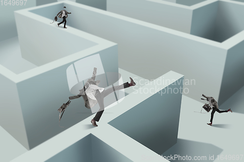 Image of Contemporary art collage. Young man without head wandering in a maze. Creativity, brain concept .