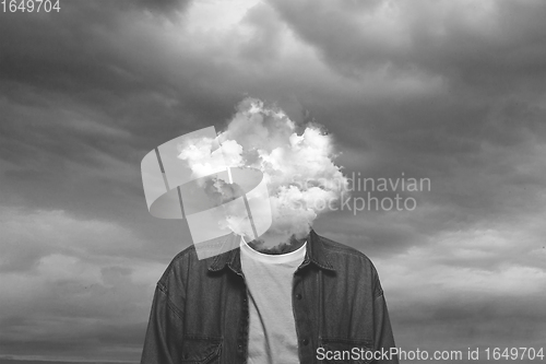 Image of Contemporary art collage. Black and white, Male body of model with head full of smoke about sky and clouds.