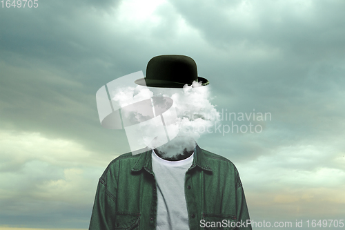 Image of Contemporary art collage. Male body of model with head full of smoke about sky and clouds.